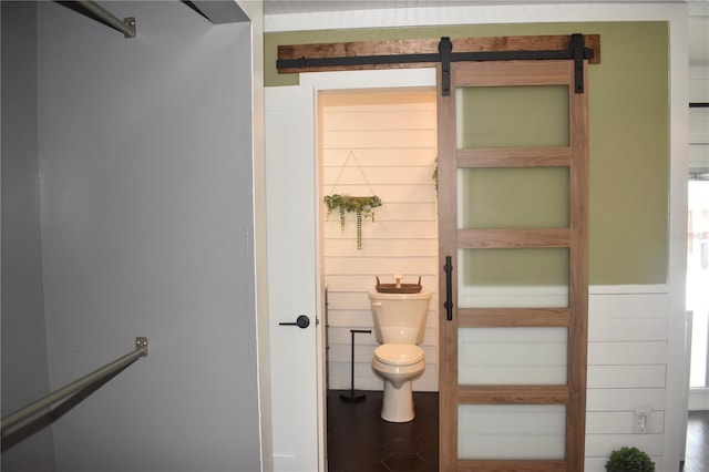 821 Silver Springs Ter NW, Port Charlotte, FL 33948 - bathroom with toilet and wood walls