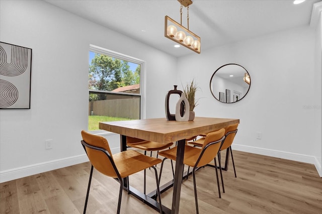 dining room featuring light wood-style flooring, baseboards, and recessed lighting