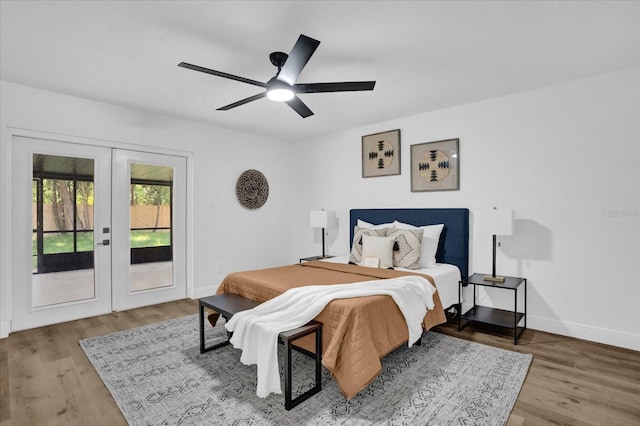 bedroom with french doors, access to outside, baseboards, wood finished floors, and ceiling fan