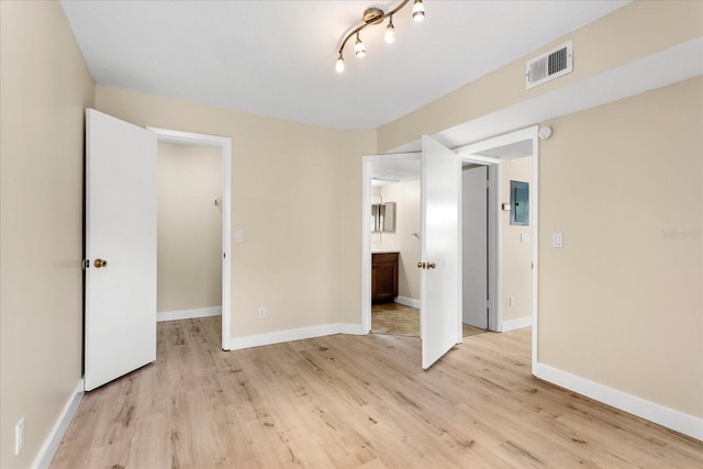 325 Forestway Cir Unit 104, Altamonte Springs, FL 32701 - unfurnished bedroom with light wood-style floors, electric panel, and baseboards