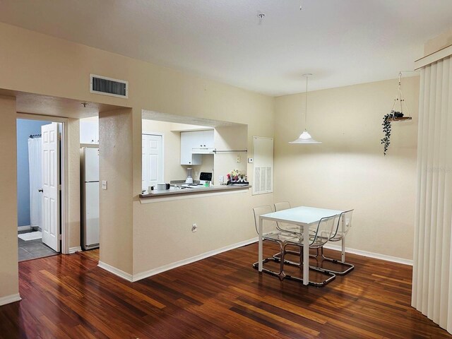 2314 Midtown Ter Unit 1126, Orlando, FL 32839 - dining room featuring dark wood-style flooring and baseboards