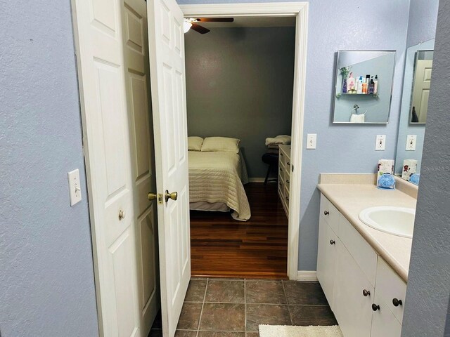 2314 Midtown Ter Unit 1126, Orlando, FL 32839 - bathroom featuring vanity, ensuite bath, ceiling fan, and a textured wall