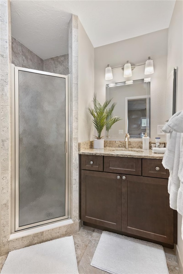 full bathroom featuring a shower stall and vanity