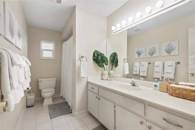 bathroom with toilet, vanity, tile patterned flooring, and baseboards