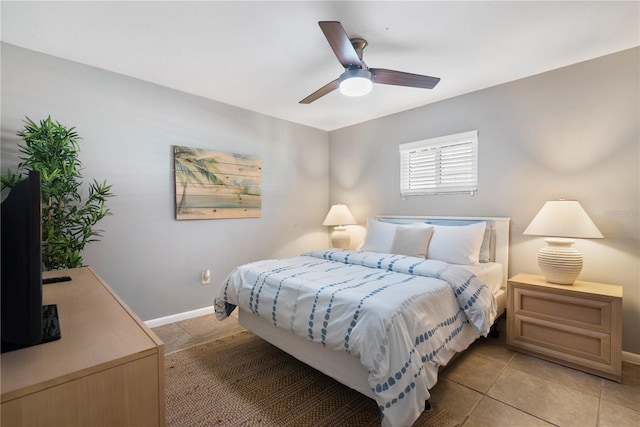 bedroom featuring light tile patterned floors, baseboards, and a ceiling fan