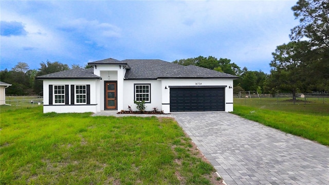 view of front of house featuring stucco siding, a garage, decorative driveway, and roof with shingles