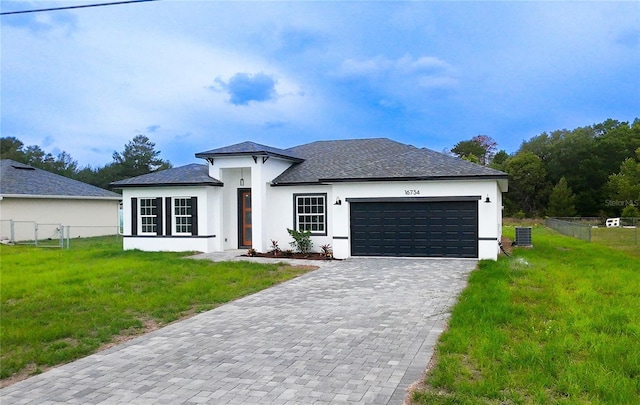 view of front of property with stucco siding, a garage, decorative driveway, and roof with shingles