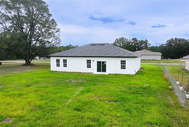 back of property featuring stucco siding and roof with shingles