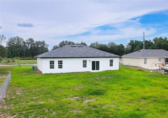 back of property featuring stucco siding and a shingled roof