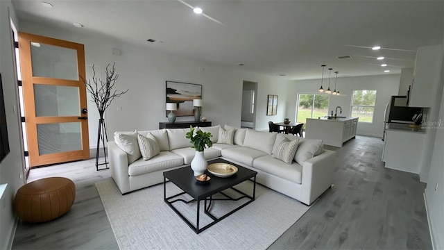 living area featuring light wood-style floors and recessed lighting