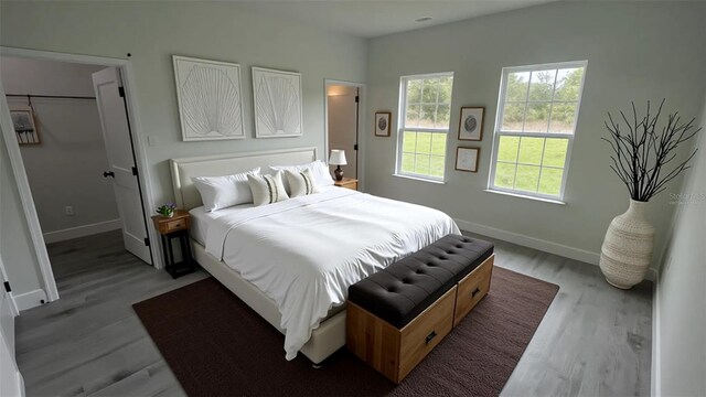 bedroom featuring wood finished floors and baseboards