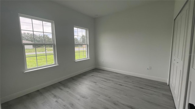 unfurnished bedroom with baseboards and wood finished floors