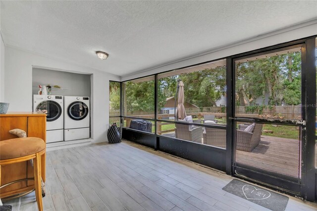 300 Hickory Ct, Apopka, FL 32712 - laundry area featuring washer and dryer, a textured ceiling, and wood finished floors