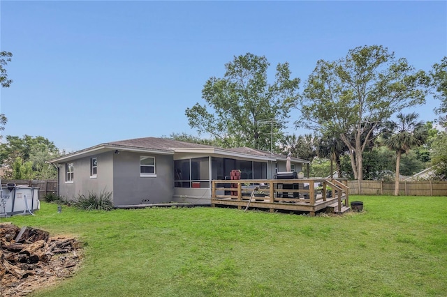 300 Hickory Ct, Apopka, FL 32712 - back of property featuring a sunroom, a wooden deck, and stucco siding