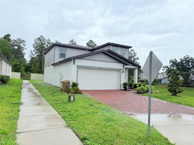 view of front of home with decorative driveway and a garage