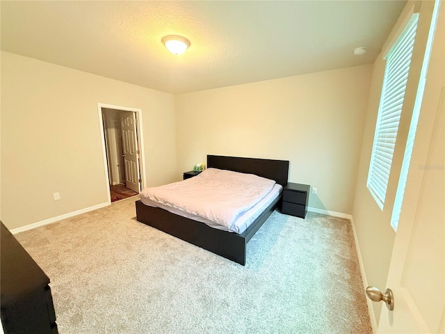 bedroom with carpet and baseboards