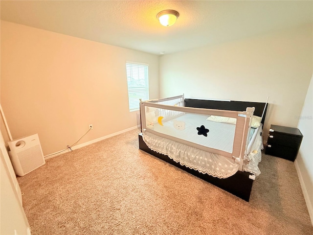carpeted bedroom featuring baseboards