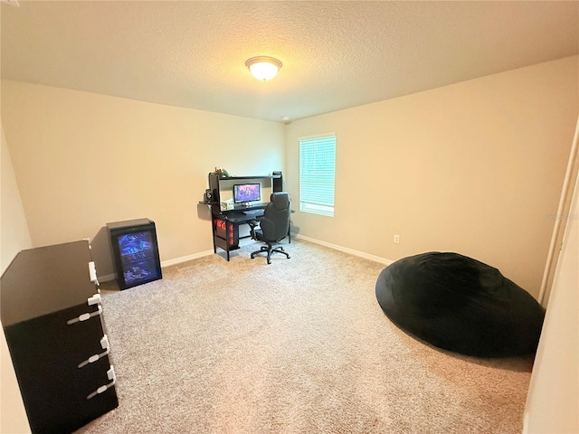 home office featuring carpet flooring, a textured ceiling, and baseboards