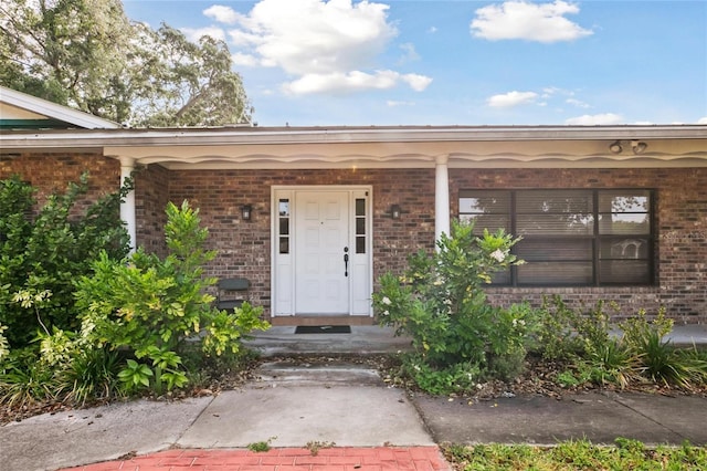 property entrance with brick siding