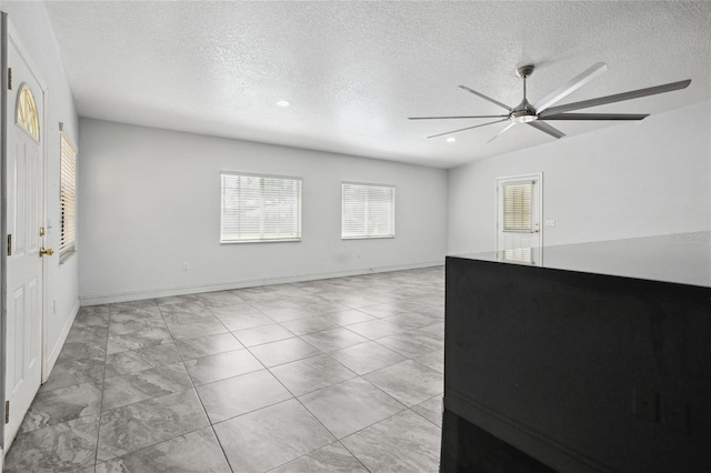 unfurnished room featuring a ceiling fan, a textured ceiling, marble finish floors, recessed lighting, and baseboards
