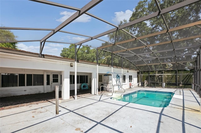view of pool with a patio area and a lanai