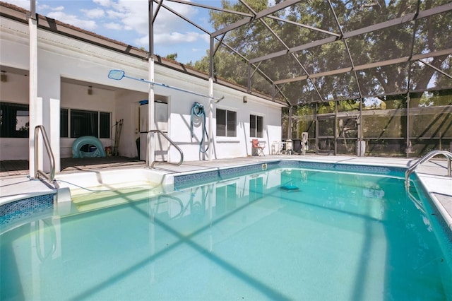 outdoor pool with a patio area and a lanai