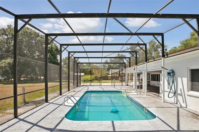 swimming pool featuring a patio area and glass enclosure