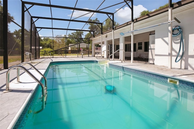 outdoor pool featuring a patio area and a lanai