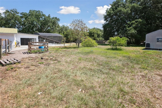 view of yard featuring fence and an outdoor structure