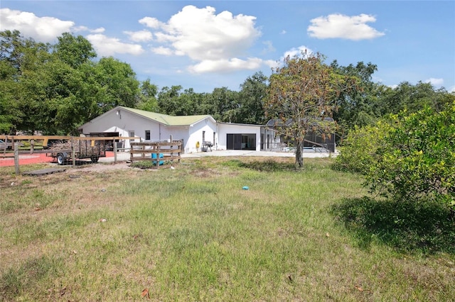 rear view of property featuring fence and stucco siding