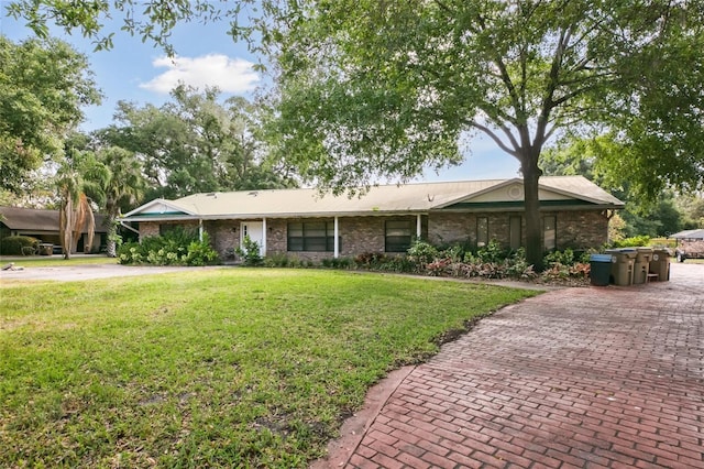 view of front facade with a front yard and brick siding