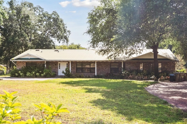 ranch-style house with a front lawn and brick siding