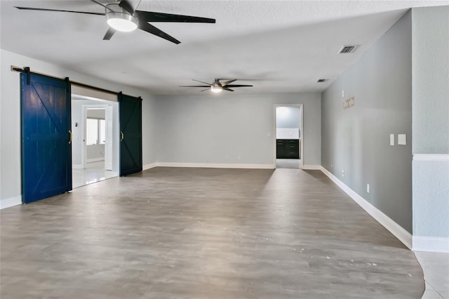 949 Shadow Oaks Rd, Kissimmee, FL 34744 - spare room featuring a barn door, ceiling fan, and wood finished floors