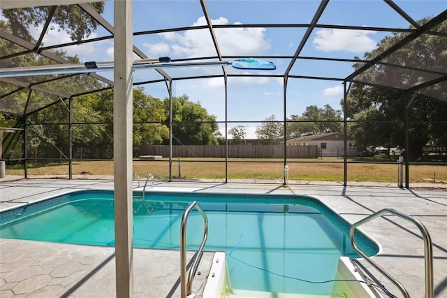 949 Shadow Oaks Rd, Kissimmee, FL 34744 - swimming pool featuring a patio area, glass enclosure, and a lawn