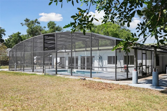 949 Shadow Oaks Rd, Kissimmee, FL 34744 - rear view of property with an outdoor pool, a lawn, a patio area, and glass enclosure