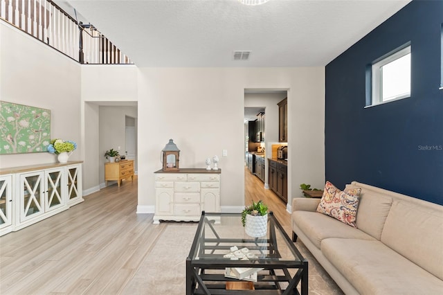 15420 Southern Martin St, Winter Garden, FL 34787 - living room with light wood-style floors, baseboards, and a textured ceiling