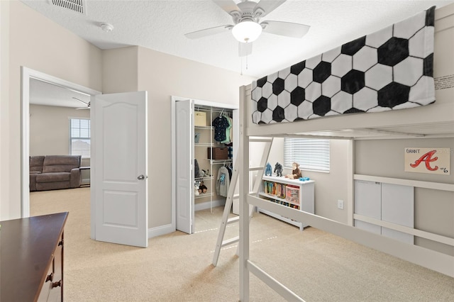 15420 Southern Martin St, Winter Garden, FL 34787 - bedroom with light carpet, multiple windows, ceiling fan, and a textured ceiling