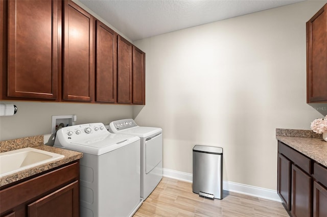 15420 Southern Martin St, Winter Garden, FL 34787 - washroom with cabinet space, separate washer and dryer, baseboards, and light wood-style floors