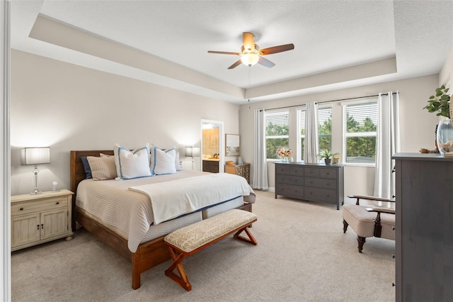 15420 Southern Martin St, Winter Garden, FL 34787 - bedroom with a raised ceiling, light carpet, a ceiling fan, and ensuite bathroom