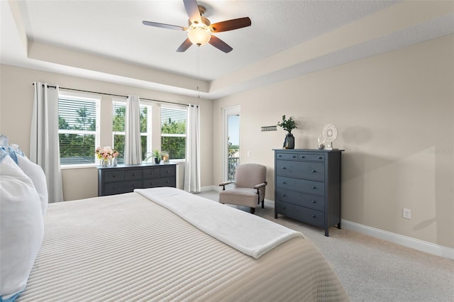 15420 Southern Martin St, Winter Garden, FL 34787 - bedroom featuring baseboards, light carpet, a ceiling fan, and a tray ceiling