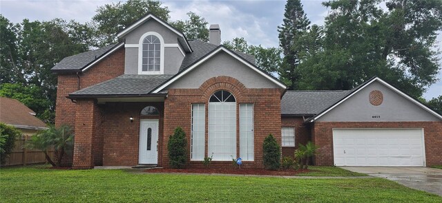 8612 Valley Ridge Ct, Orlando, FL 32818 - view of front of home with brick siding, a shingled roof, a chimney, concrete driveway, and an attached garage