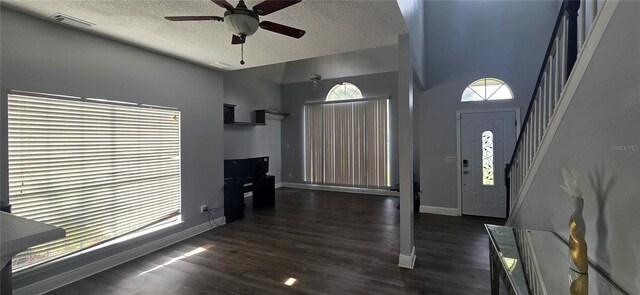8612 Valley Ridge Ct, Orlando, FL 32818 - foyer with a ceiling fan, stairs, baseboards, a textured ceiling, and dark wood-style flooring