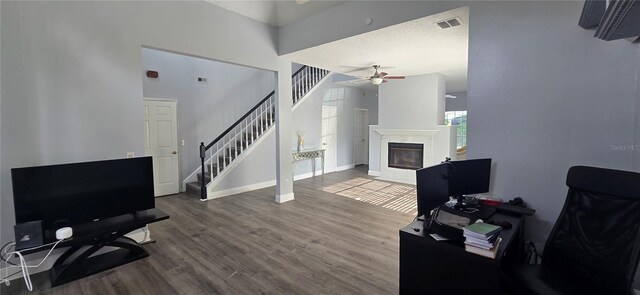 8612 Valley Ridge Ct, Orlando, FL 32818 - living room featuring ceiling fan, stairway, wood finished floors, a glass covered fireplace, and baseboards