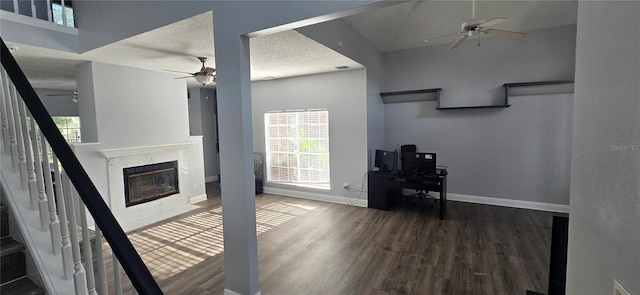 8612 Valley Ridge Ct, Orlando, FL 32818 - living area with a ceiling fan, wood finished floors, a high end fireplace, baseboards, and a textured ceiling