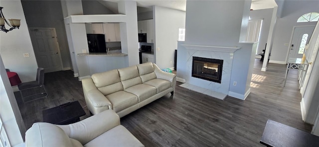 8612 Valley Ridge Ct, Orlando, FL 32818 - living room with dark wood-style floors, a fireplace, baseboards, and a high ceiling