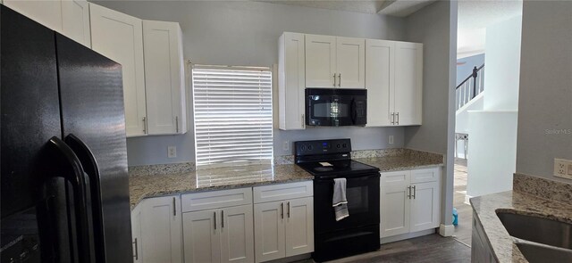8612 Valley Ridge Ct, Orlando, FL 32818 - kitchen featuring black appliances, white cabinetry, and light stone countertops