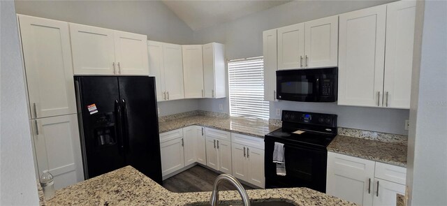 8612 Valley Ridge Ct, Orlando, FL 32818 - kitchen with black appliances, vaulted ceiling, white cabinets, light stone counters, and a sink