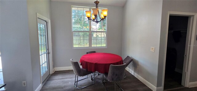 8612 Valley Ridge Ct, Orlando, FL 32818 - dining space with a chandelier, baseboards, and wood finished floors