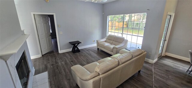 8612 Valley Ridge Ct, Orlando, FL 32818 - living area with a fireplace with flush hearth, baseboards, dark wood-type flooring, and ceiling fan