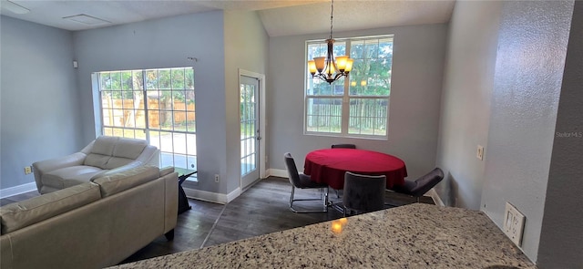 8612 Valley Ridge Ct, Orlando, FL 32818 - dining area featuring a chandelier, dark wood finished floors, healthy amount of natural light, and baseboards